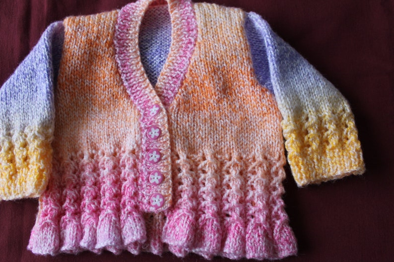 Baby girl/'s knitted multi coloured cardigan new born size.
