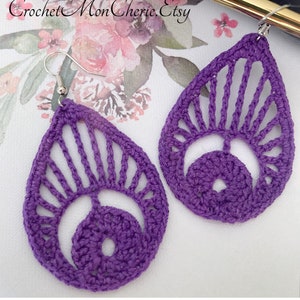 May include: A pair of purple crocheted earrings with a teardrop shape and a delicate openwork design. The earrings are made with a fine yarn and have a simple, elegant style.