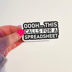 May include: A white sticker with black text that reads "OOOOH... THIS CALLS FOR A SPREADSHEET".