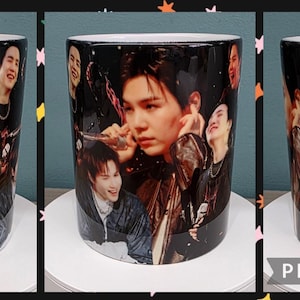 May include: White ceramic mug with a collage of images of several people printed on its black surface. The mug has a white handle and a white interior. The text "PIC•COLLAGE" is visible.
