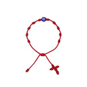May include: Red string bracelet with a blue evil eye charm and a small red cross at the end.