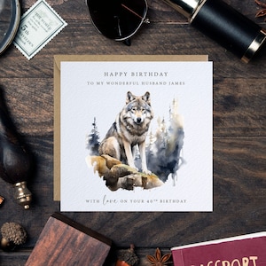 May include: A birthday card featuring a watercolour illustration of a wolf in a woodland setting. The card reads "Happy Birthday to my wonderful husband James" and "With love on your 40th Birthday".