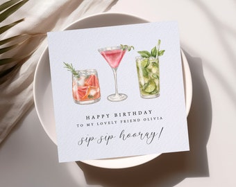 May include: A blue card with three watercolor illustrations of cocktails. The text reads "Happy Birthday to my lovely friend Olivia sip sip hooray!"