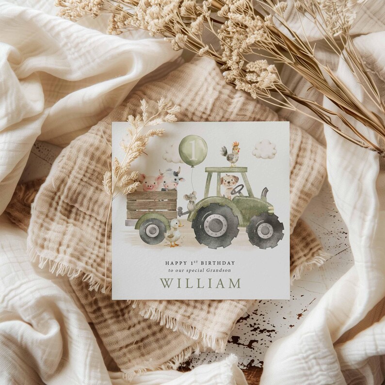 May include: A green tractor with a number one balloon, a rooster, a pig, a cow, a duck, and a dog on it. The text "Happy 1st Birthday to our special grandson WILLIAM" is below the tractor.