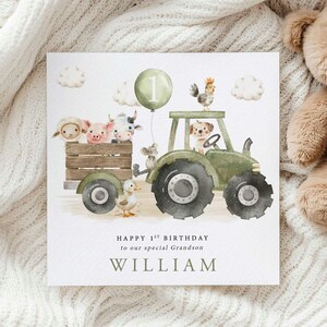 First Birthday card with a green tractor and trailer carrying a range of cute farm animals