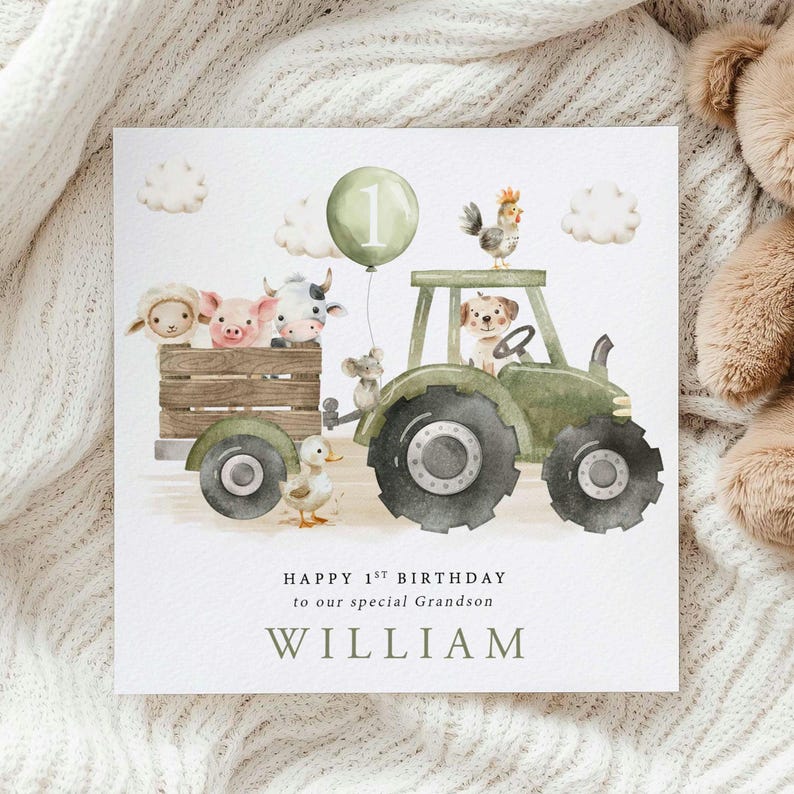 First Birthday card with a green tractor and trailer carrying a range of cute farm animals