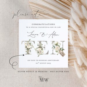 May include: A white card with a floral design spelling out the word "TEN" to celebrate a 10th wedding anniversary. The card reads "Congratulations to a special daughter & son-in-law Laura & Alan on your Tin Wedding Anniversary 24th August 2025. Silver effect is printed - not silver foil. MW"