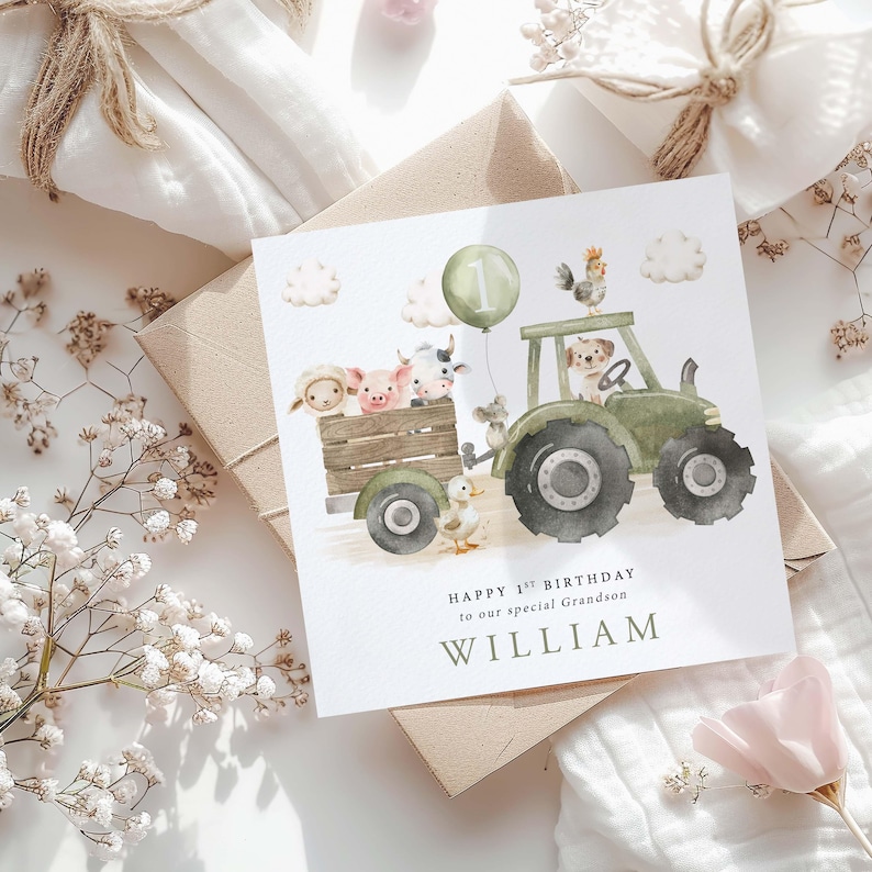 May include: A green tractor with a wooden wagon filled with farm animals. A balloon with the number one is attached to the tractor. The text "Happy 1st Birthday to our special Grandson WILLIAM" is printed below the tractor.