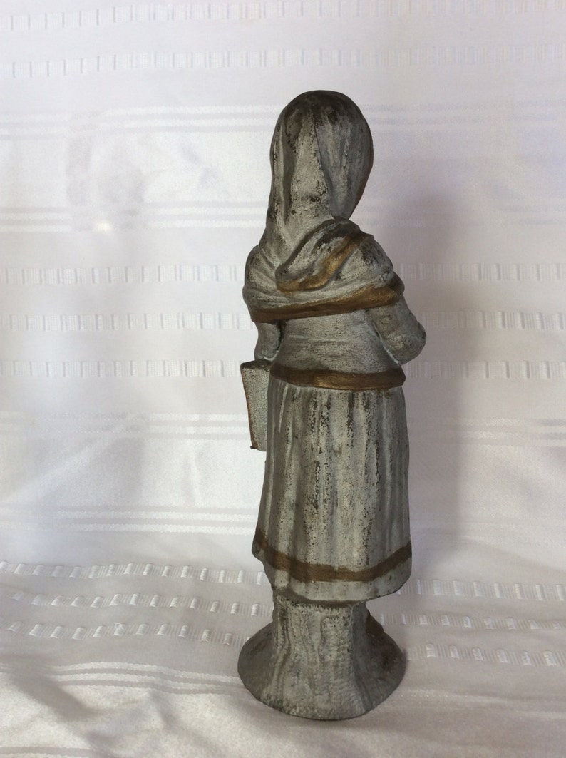 Antique white metal girl statue figurine going to her music lesson