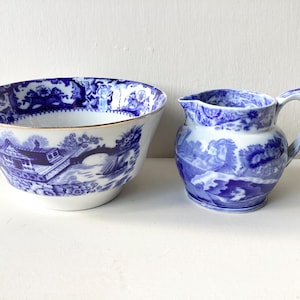May include: A blue and white porcelain tea set with a delicate floral pattern. The set includes a creamer and a sugar bowl.