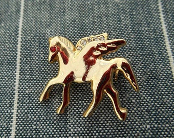 gold tone pegasus brooch with rhinestone eye / costume jewelry / unmarked / vintage