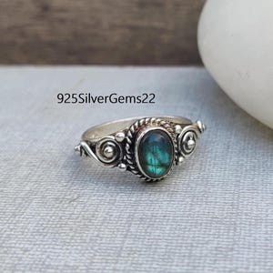 May include: A silver ring with a green labradorite gemstone and intricate silver detailing. 925SilverGems22.