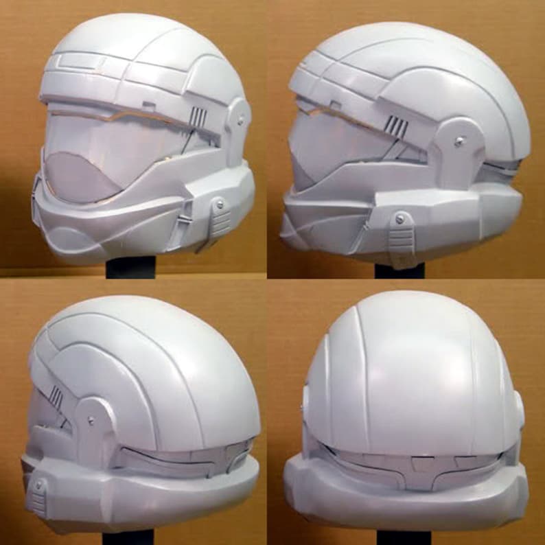 May include: Four white plastic helmets with a futuristic design. The helmets have a visor and a chin guard. The helmets are shown from different angles.