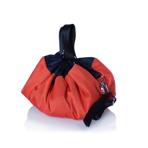 May include: A red drawstring bag with a black handle and a mesh design. The bag is made of a lightweight material and has a drawstring closure.