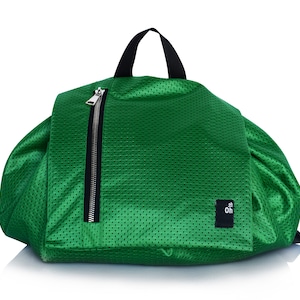 May include: A green mesh backpack with a black zipper and a black label with the text "oh" on it.