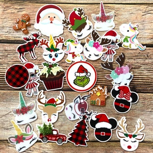 May include: A collection of Christmas-themed embellishments, including Santa Claus, reindeer, unicorns, gingerbread men, and a red truck carrying a Christmas tree. The designs feature festive colors like red, green, and white, with plaid and floral accents.