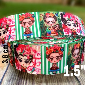 May include: Green and white striped ribbon with a repeating pattern of colorful illustrations of Frida Kahlo. The ribbon is 1.5 inches wide and 3.8 cm in diameter.