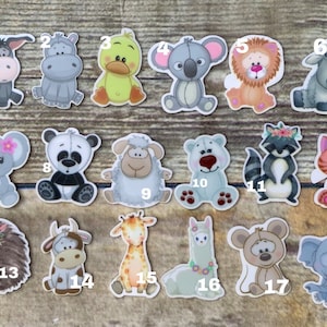 May include: Set of 18 colorful animal-themed iron-on patches. The patches feature a variety of animals, including a donkey, hippopotamus, duck, koala, lion, sheep, panda, polar bear, raccoon, cat, hedgehog, cow, giraffe, llama, mouse, and elephant. The patches are perfect for adding a touch of whimsy to clothing, bags, or other fabric items.