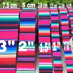 May include: A set of six colorful striped ribbon rolls in various widths, ranging from 5/8 inch to 3 inches. The ribbon is a bright red, pink, blue, green, and white striped pattern.