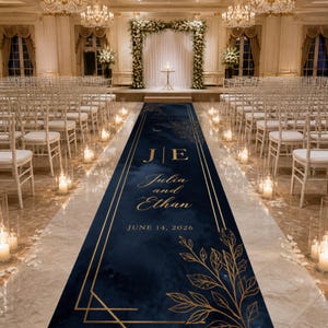 May include: A navy blue wedding aisle runner with gold accents and the names "Julia and Ethan" and the date "June 14, 2026". The runner is decorated with gold geometric shapes and floral designs.