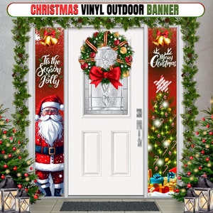 May include: Three Christmas-themed vinyl banners for a front door. The left banner features a Santa Claus illustration with the text "Tis the Season to be Jolly". The middle banner is a red and gold wreath with a red bow. The right banner features a Christmas tree with presents and the text "Merry Christmas".