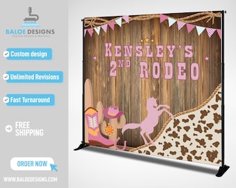 May include: A pink and brown backdrop for a birthday party with the text "KENSLEY'S 2ND RODEO" on a wooden background. The backdrop features a pink horse, cowboy boots, and a cactus.