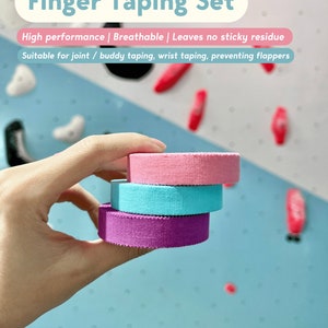 May include: A Finger Taping Set consisting of three stacked rolls of athletic tape in pink, light blue, and purple. The text on the image reads: Finger Taping Set, High performance | Breathable | Leaves no sticky residue, Suitable for joint / buddy taping, wrist taping, preventing flappers, and grip jammers.