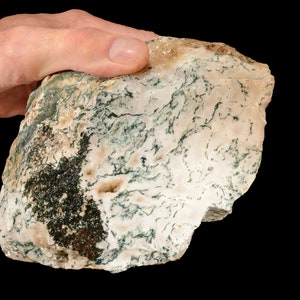 May include: A large, irregularly shaped piece of moss agate with a white and green colour pattern. The agate has a rough, natural surface.