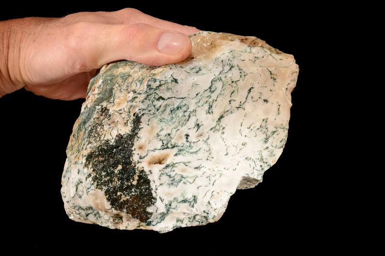 May include: A large, irregularly shaped piece of moss agate with a white and green colour pattern. The agate has a rough, natural surface.