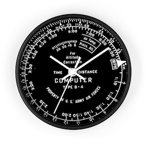 May include: A black and white circular analogue clock with a black face and white markings. The clock face has the words "COMPUTER TYPE D-4" and "PROPERTY OF U.S. ARMY AIR FORCES".