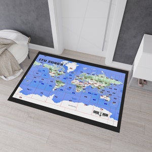 May include: A black and blue world map rug with the text "ITU ZONES" and a grid of numbers. The rug is on a light wood floor.