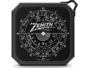 May include: Black and white vintage-style radio with a round dial featuring the text "ZENITH LONG DISTANCE" and numbers from 25 to 150. The radio has a black, octagonal shape with a carrying handle.
