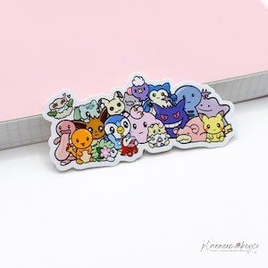 May include: A die-cut vinyl sticker featuring a colorful, crowded illustration of various cartoon creatures including a yellow electric mouse, a purple ghost, a blue penguin, and an orange lizard, all arranged in a dense, overlapping group.