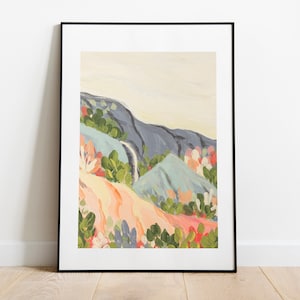 May include: A framed abstract painting of a landscape with blue, green, and pink hues. The painting depicts a mountain range with a waterfall flowing down the side.