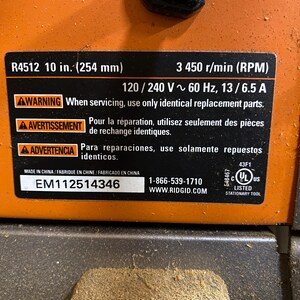 May include: Close-up of a black and orange power tool with a label. The label includes the model number R4512, 10 in. (254 mm), and other specifications. It also has a warning about using identical replacement parts.