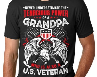 May include: Black t-shirt with a graphic design featuring an eagle with American flags and the text "Never underestimate the tenacious power of a grandpa who is also a U.S. veteran."