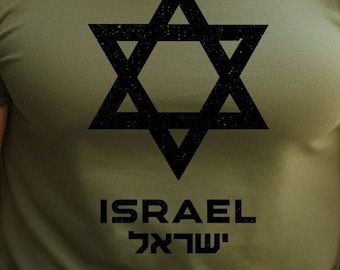 May include: Olive green t-shirt featuring a large black Star of David graphic. Below the star, the word "ISRAEL" is printed in a bold, sans-serif font, with the Hebrew word for Israel beneath it.
