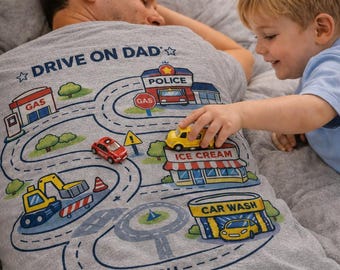 Playmat t-shirt for dad, toddler drives toy cars on city road map back, screen-free father's day gift from kids, car track grandpa t-shirt