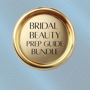 May include: A gold-colored circular emblem with the text "BRIDAL BEAUTY PREP GUIDE BUNDLE" in black. The emblem has a raised, rounded border and sits against a light blue background.
