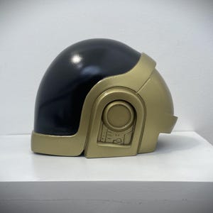 May include: A set of three ceramic mugs with a speckled, matte finish. The mugs are in shades of cream, light grey, and dark grey. Each mug has a simple, minimalist design, ideal for coffee or tea.