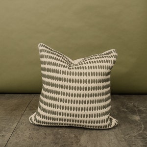 Our selfoss pillow cover. A white/cream pillow cover with olive green details.