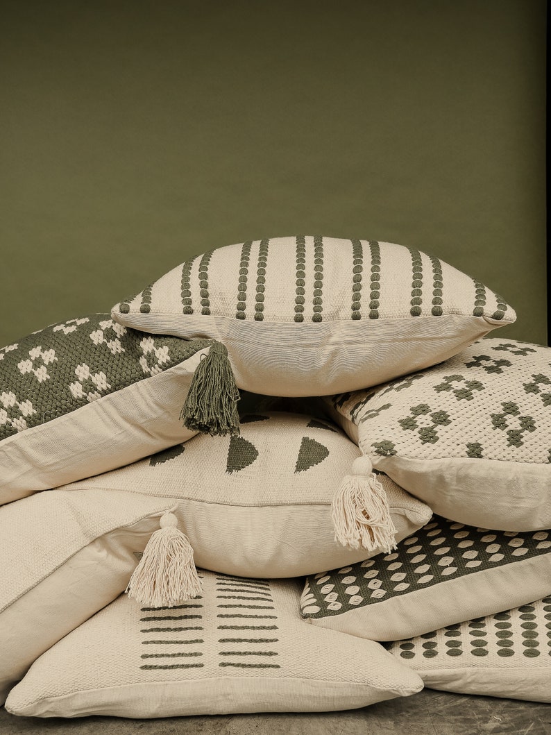 Our selfoss pillow cover. A white/cream pillow cover with olive green details. Mix and match with other covers from our shop!