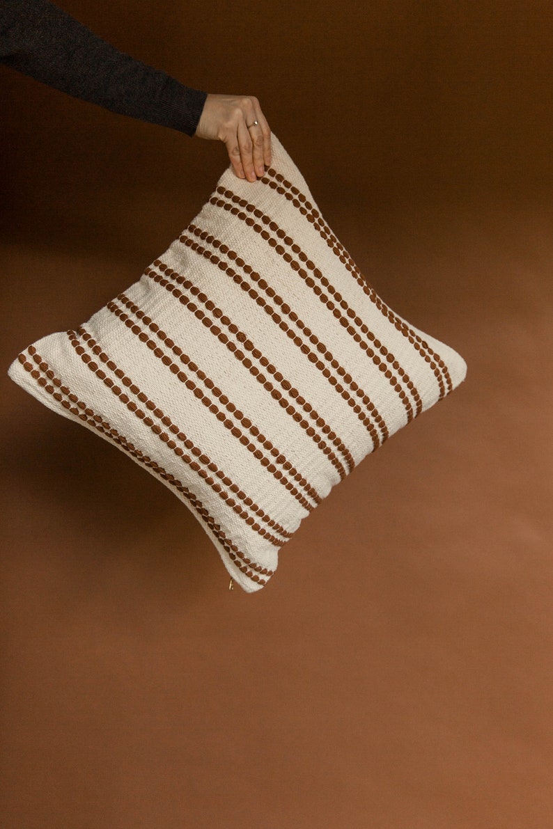 The Rome pillow cover in rust. A cotton woven pillow cover.