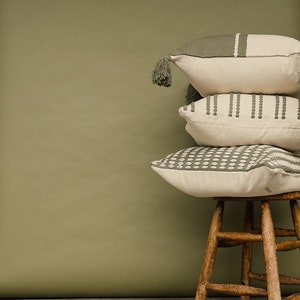 Our selfoss pillow cover. A white/cream pillow cover with olive green details. Mix and match with other covers from our shop!