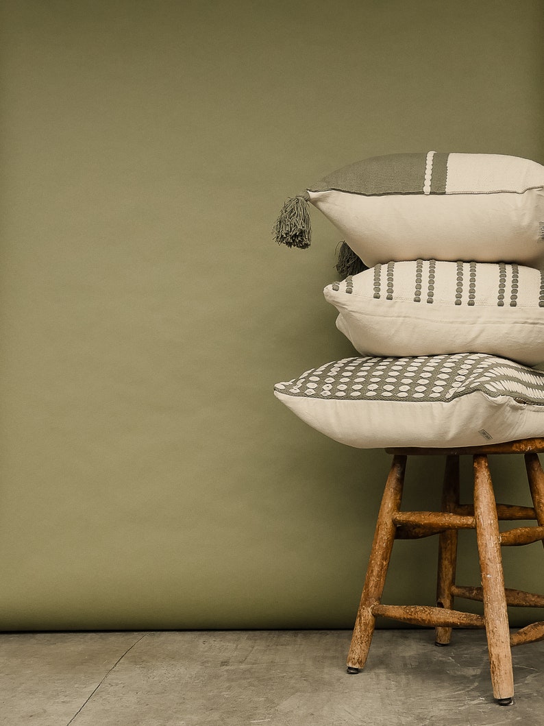 Our selfoss pillow cover. A white/cream pillow cover with olive green details. Mix and match with other covers from our shop!