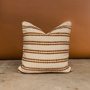 The Rome pillow cover in rust. A cotton woven pillow cover.