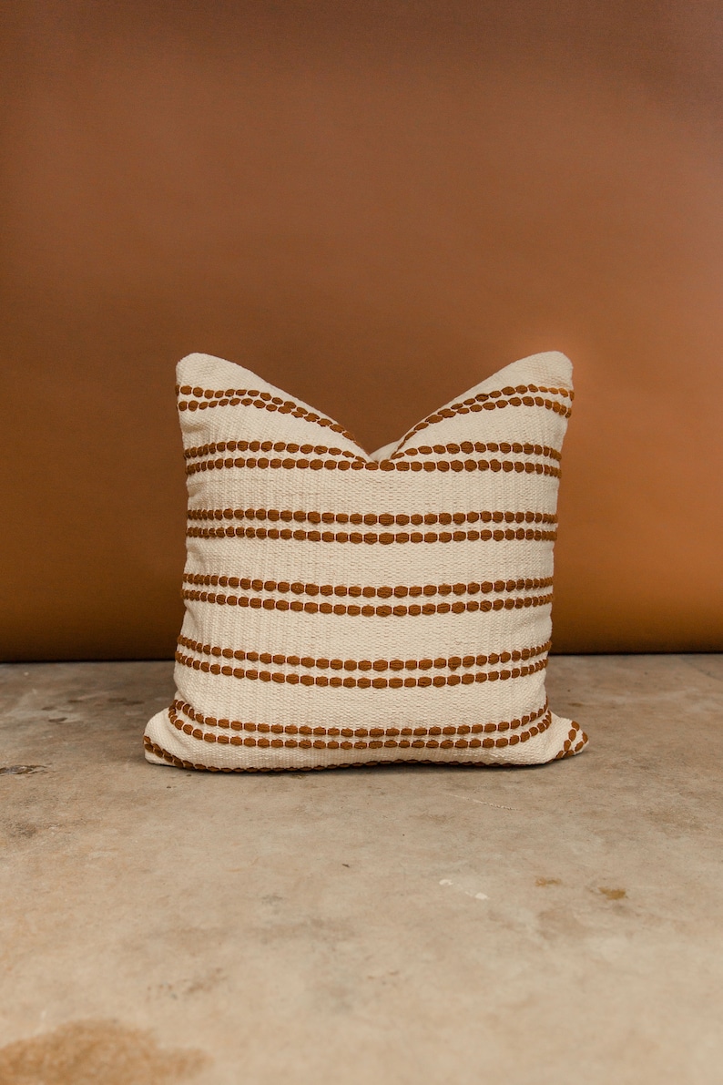 The Rome pillow cover in rust. A cotton woven pillow cover.