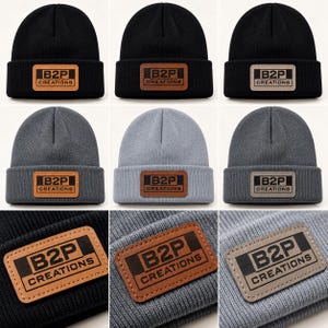 May include: A collection of knit beanies in black, dark grey, and light grey, each featuring a rectangular patch with the text B2P CREATIONS. The patches are available in tan, brown, or grey, stitched onto the folded cuff of each hat.