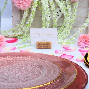 Personalized Horizontal Cork Place Card Holder, Laser Engraved. Design 5, Used for Rustic Wedding Place Cards, Wedding Booth, Parties and Table Decorations. on a wooden base with decorative flowers. for wedding favors