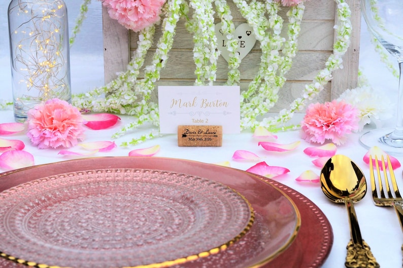 Personalized Horizontal Cork Place Card Holder, Laser Engraved. Design 5, Used for Rustic Wedding Place Cards, Wedding Booth, Parties and Table Decorations. on a wooden base with decorative flowers. for wedding favors